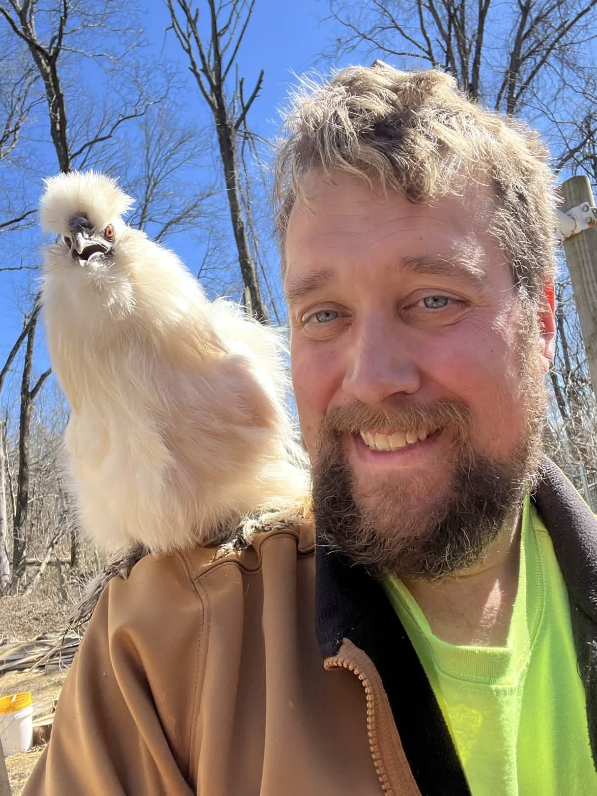 Holding a Silkie from the previous flock — fluffier than they look.